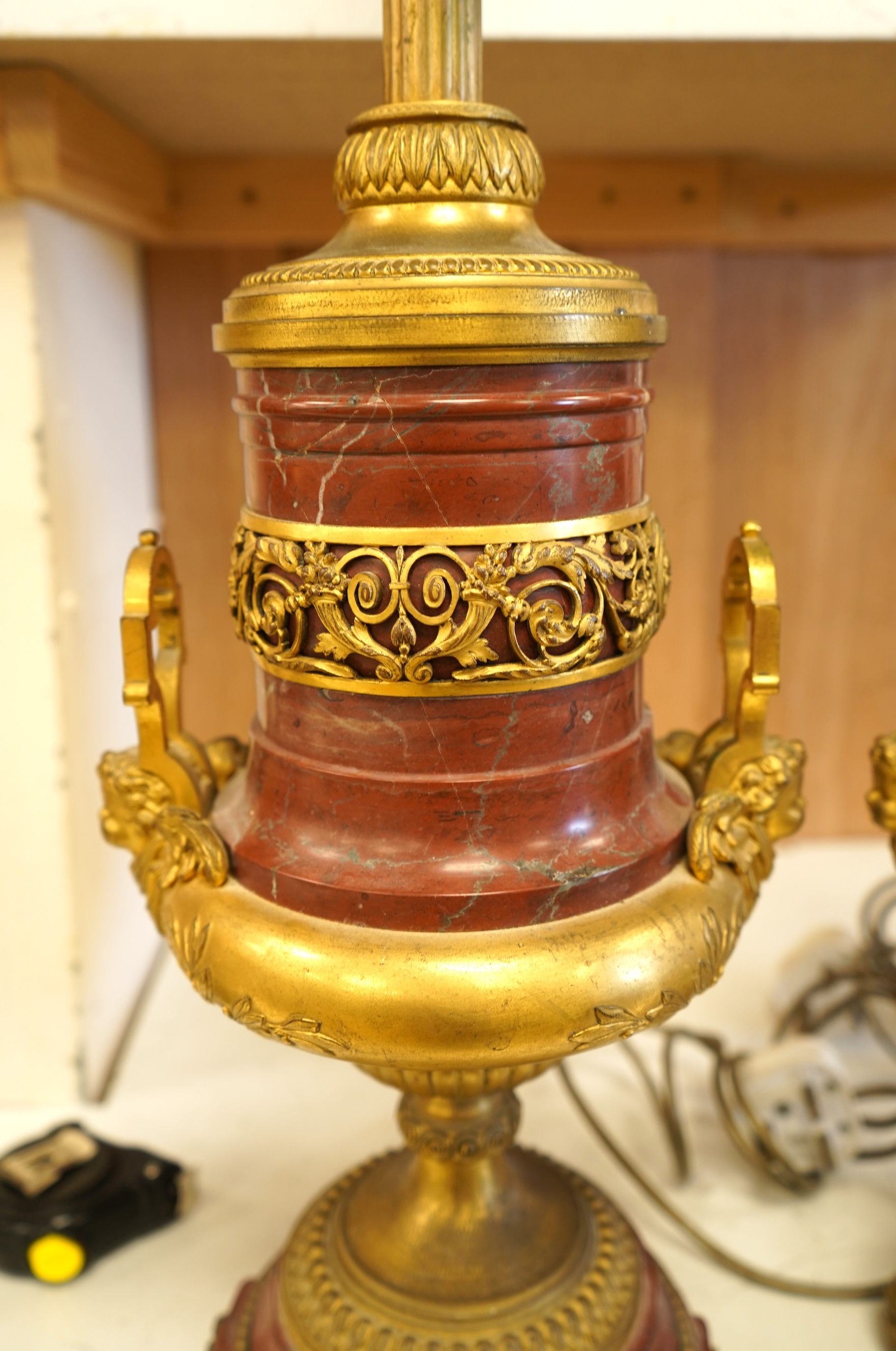 A pair of Empire style gilt metal and rouge marble table lamps, 50cm